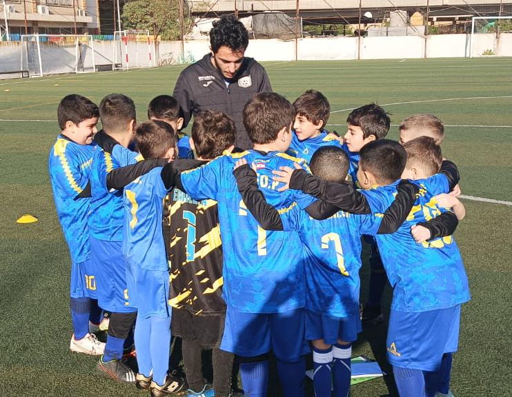 Youth players huddling during football practice